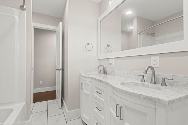 bathroom with vanity and shower / washtub combination