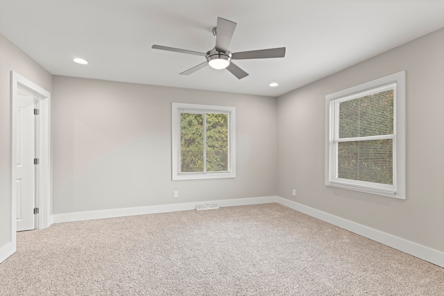 carpeted empty room featuring ceiling fan