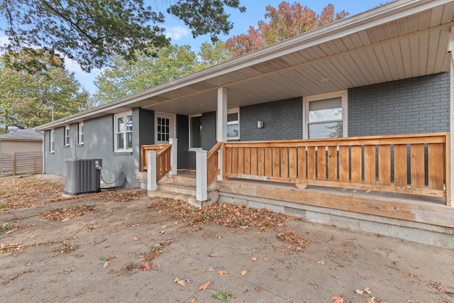 view of exterior entry featuring central AC unit