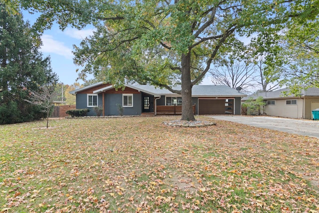 ranch-style home featuring a front yard and a garage