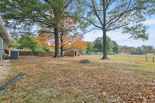 view of yard with a storage shed and central AC