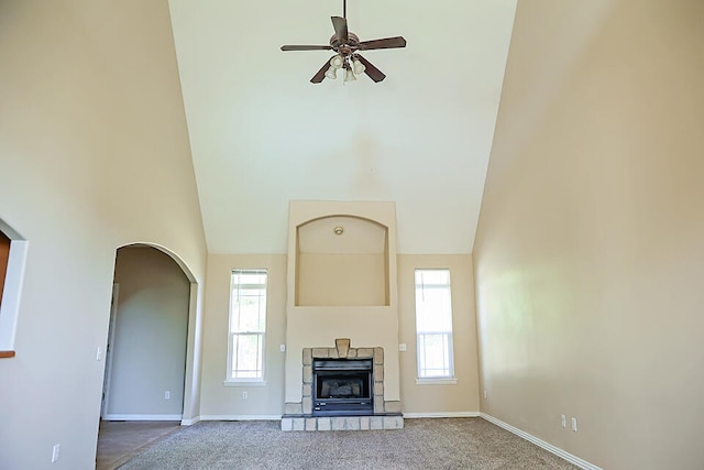 unfurnished living room with a towering ceiling and carpet flooring