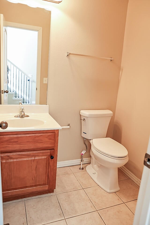 bathroom featuring tile patterned floors, vanity, and toilet