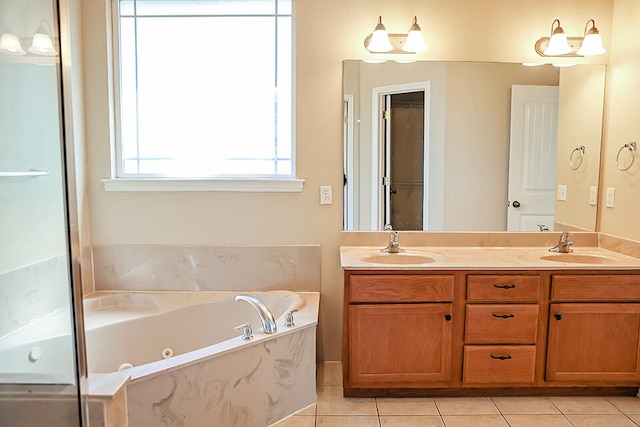 bathroom featuring tiled tub, tile patterned floors, and vanity