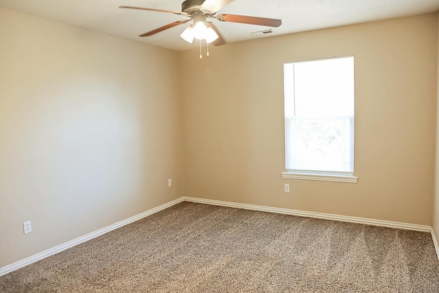 carpeted spare room with ceiling fan