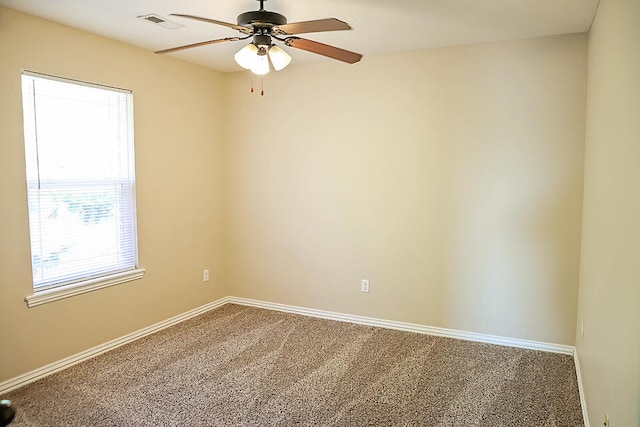 carpeted spare room featuring ceiling fan