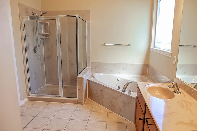 bathroom featuring tile patterned flooring, vanity, and shower with separate bathtub