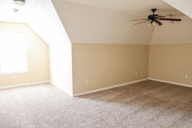 bonus room with lofted ceiling, carpet flooring, and ceiling fan