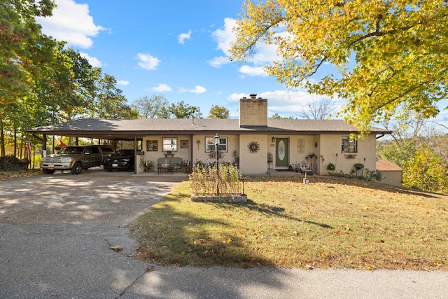 ranch-style home with a carport and a front yard