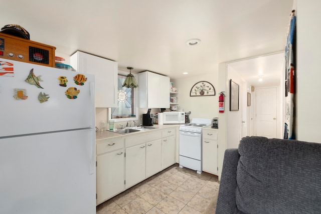 kitchen featuring light tile patterned flooring, white appliances, white cabinets, and sink