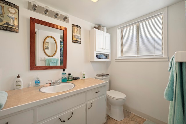 bathroom featuring tile patterned floors, vanity, and toilet