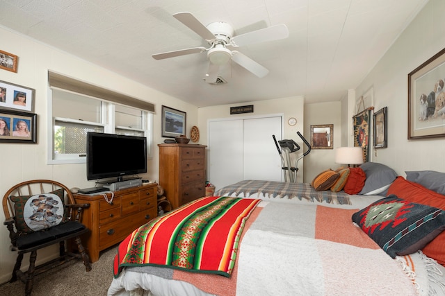 carpeted bedroom with ceiling fan and a closet