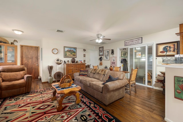 living room with ceiling fan and dark hardwood / wood-style flooring