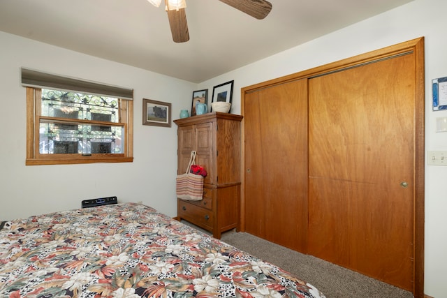 bedroom with ceiling fan, a closet, and carpet flooring