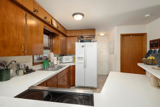 kitchen with sink and white appliances