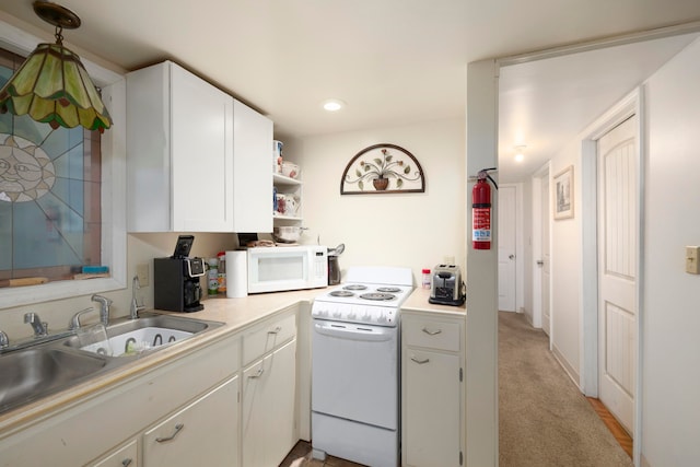 kitchen featuring white cabinets, light colored carpet, sink, and white appliances