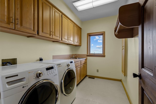 washroom featuring light carpet, cabinets, sink, and washer and dryer