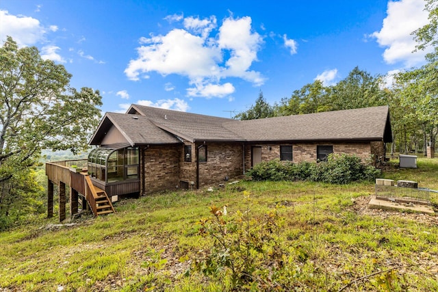 rear view of property with a wooden deck