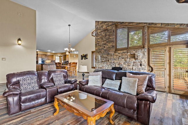 living room with high vaulted ceiling, an inviting chandelier, and wood-type flooring