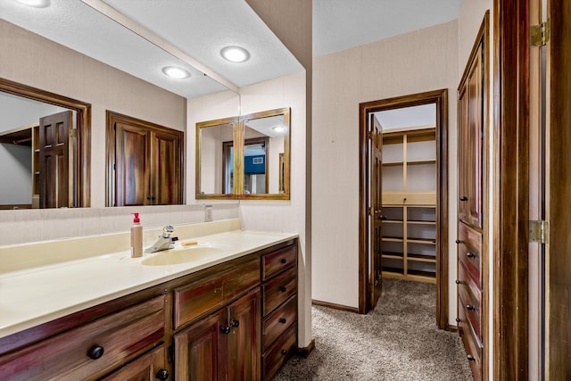 bathroom with vanity and a textured ceiling