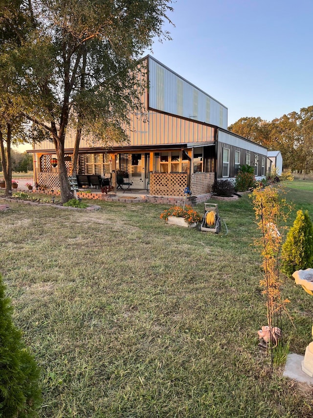 back of house with a yard and a patio