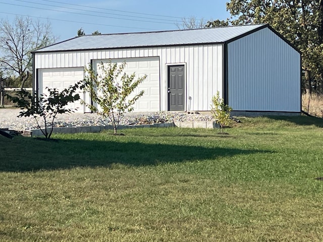 view of outbuilding featuring a yard and a garage