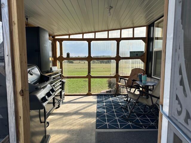 sunroom with wooden ceiling and lofted ceiling