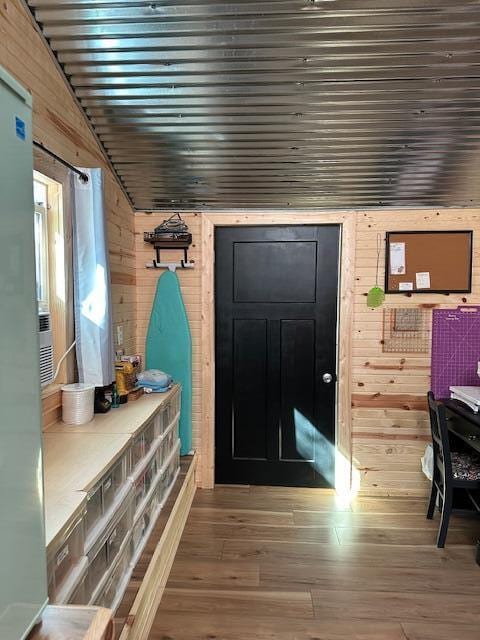 mudroom featuring wooden walls and hardwood / wood-style floors