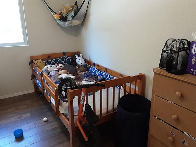 bedroom featuring dark hardwood / wood-style flooring