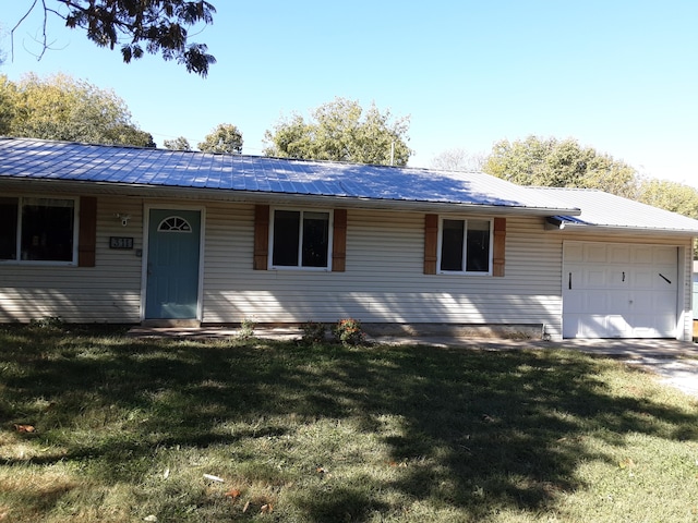 ranch-style house with a front yard and a garage