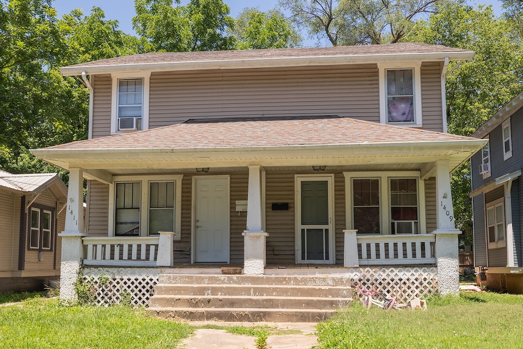 view of front of property with a porch and cooling unit