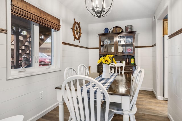 dining area with a notable chandelier and wood-type flooring