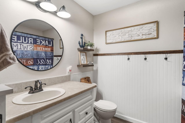 bathroom featuring toilet, vanity, and wood-type flooring