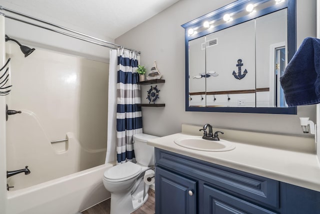 full bathroom with a textured ceiling, hardwood / wood-style flooring, toilet, vanity, and shower / tub combo with curtain