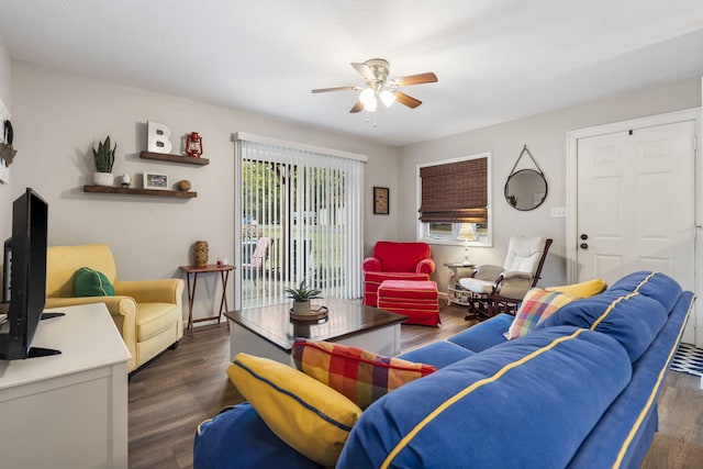 living room with ceiling fan and dark hardwood / wood-style flooring