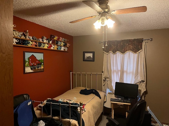 bedroom with ceiling fan and a textured ceiling