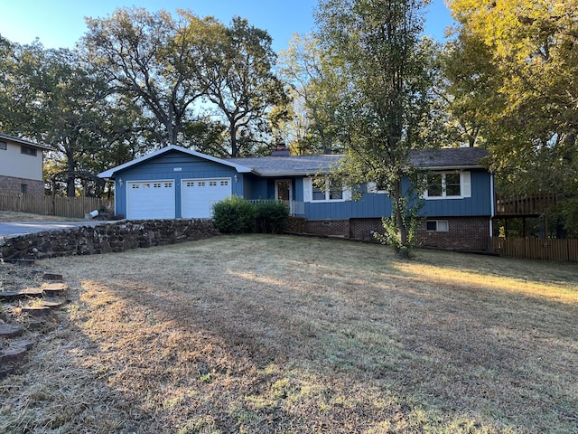 single story home with a front yard and a garage