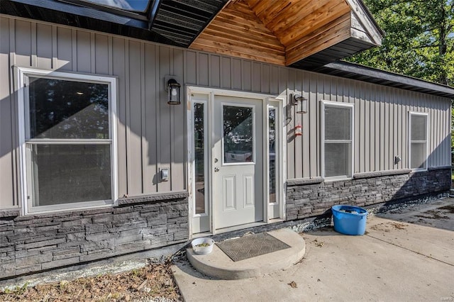 view of exterior entry with a patio area