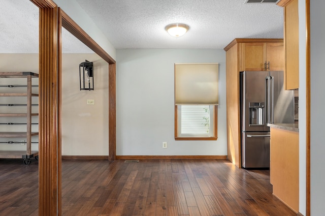 kitchen with high end fridge, a textured ceiling, and dark hardwood / wood-style floors