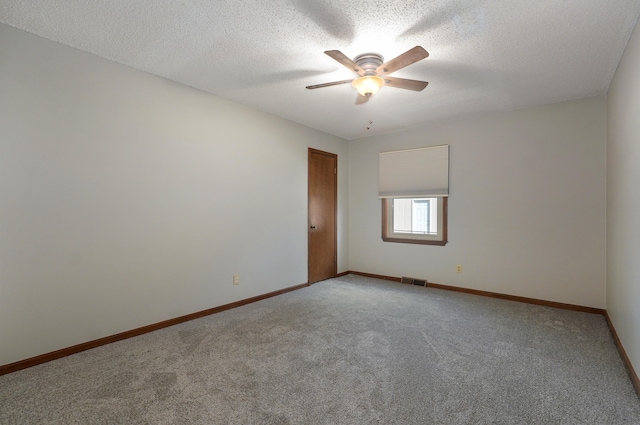 unfurnished room featuring a textured ceiling, carpet flooring, and ceiling fan