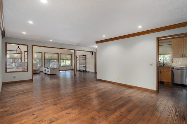 unfurnished living room with crown molding, dark hardwood / wood-style floors, and a textured ceiling