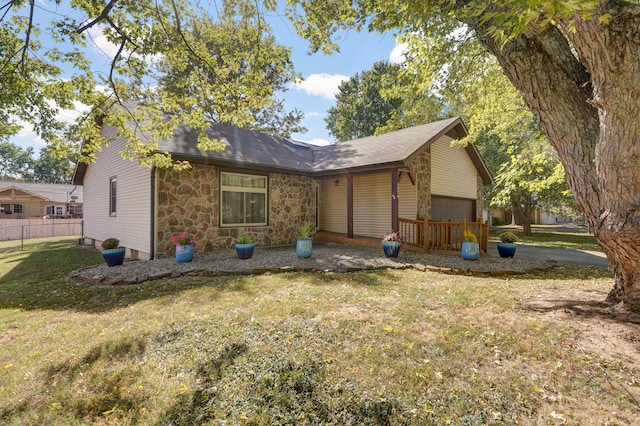 back of house with a lawn