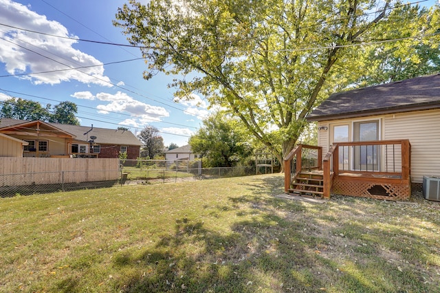 view of yard with central AC and a deck