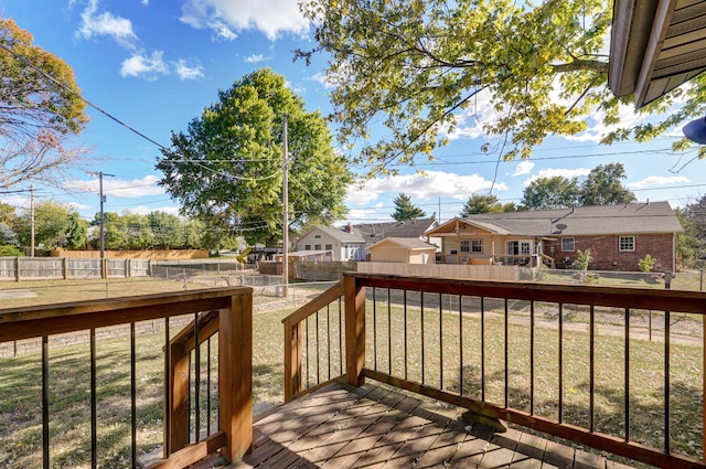 wooden terrace featuring a yard