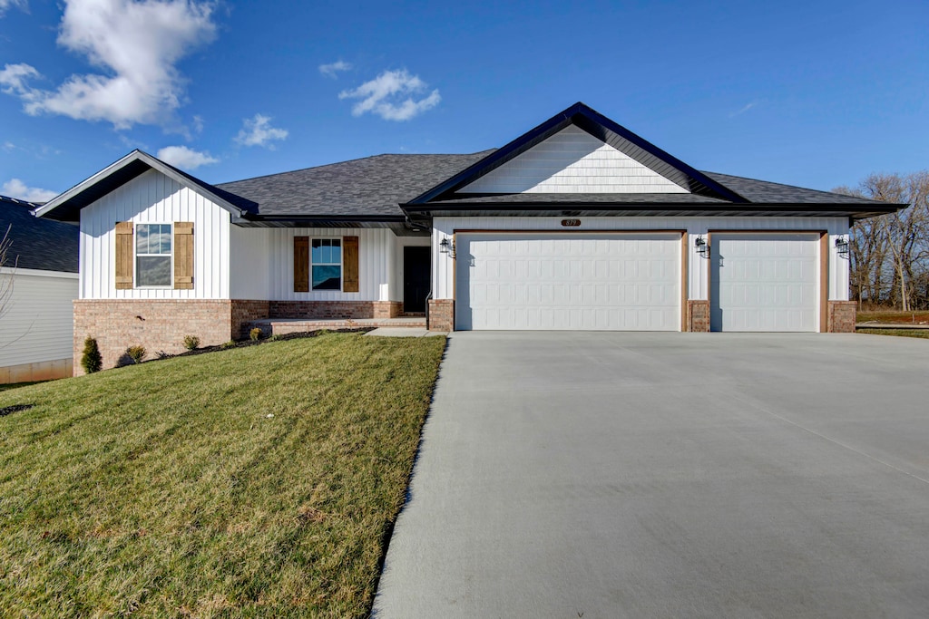 view of front of property with a garage and a front lawn