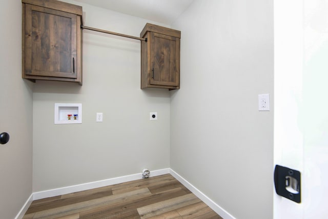 washroom with hookup for a washing machine, hardwood / wood-style floors, cabinets, and hookup for an electric dryer