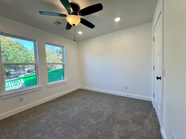 carpeted spare room featuring ceiling fan