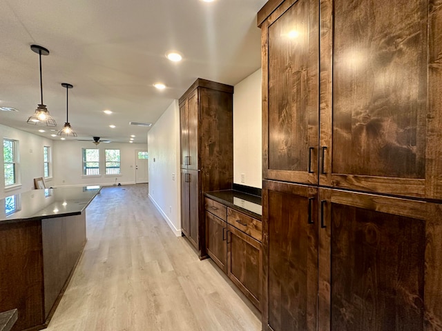 kitchen with pendant lighting, ceiling fan, dark brown cabinets, and light wood-type flooring