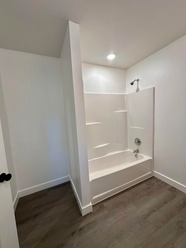 bathroom featuring bathtub / shower combination and wood-type flooring