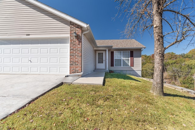 view of front of house featuring a garage and a front lawn